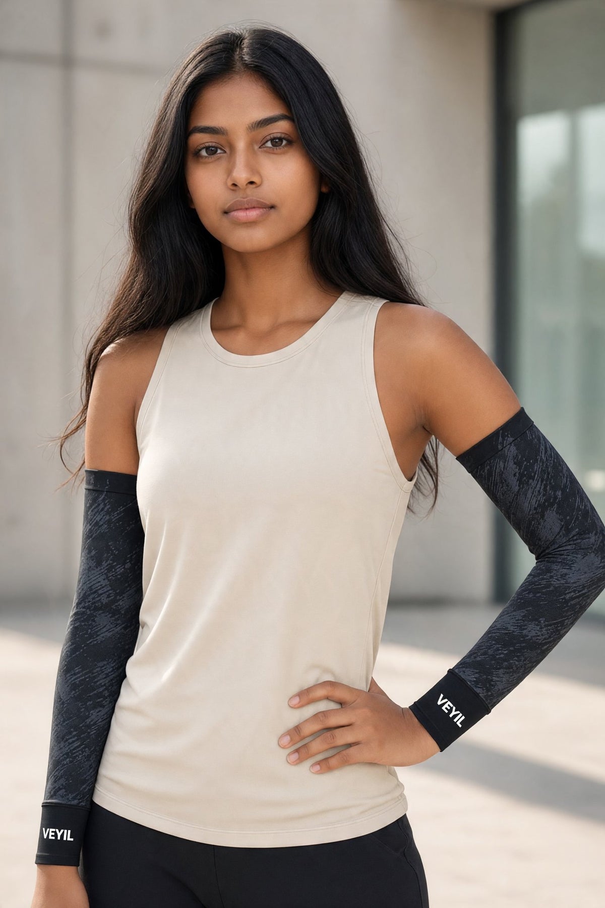 Woman wearing black VEYIL UPF 50+ cooling arm sleeves with a sleeveless top